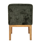 Rear view of the dining chair showing mottled olive upholstery across the rounded back above a warm brown horizontal rail and legs.