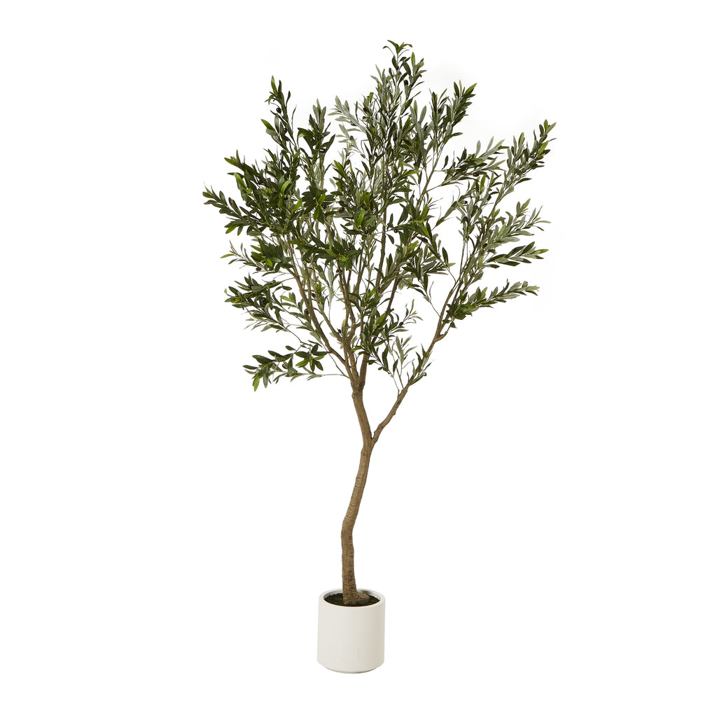 Full view of the artificial tree with a slender brown trunk, high leafy crown and white cylindrical pot.