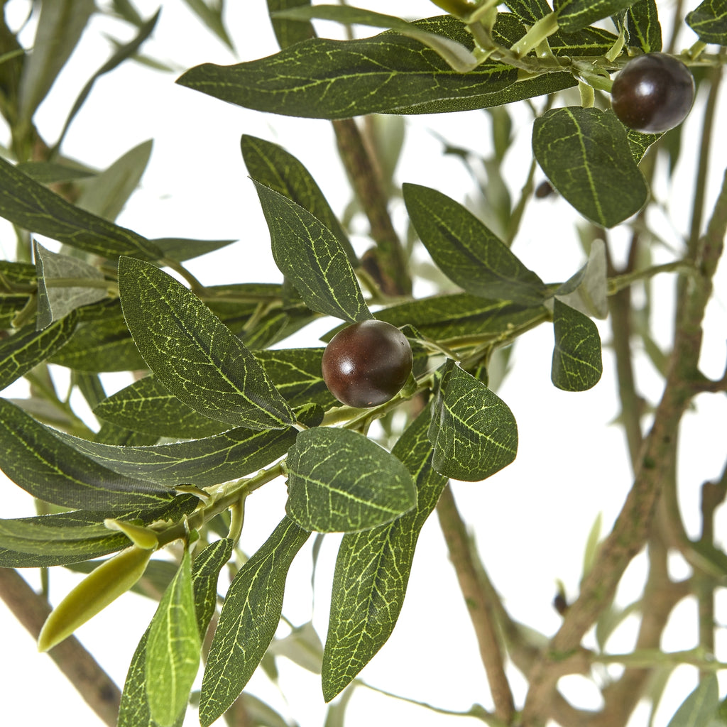 Close-up of narrow artificial green leaves with pale vein markings and dark rounded olive-like fruits.