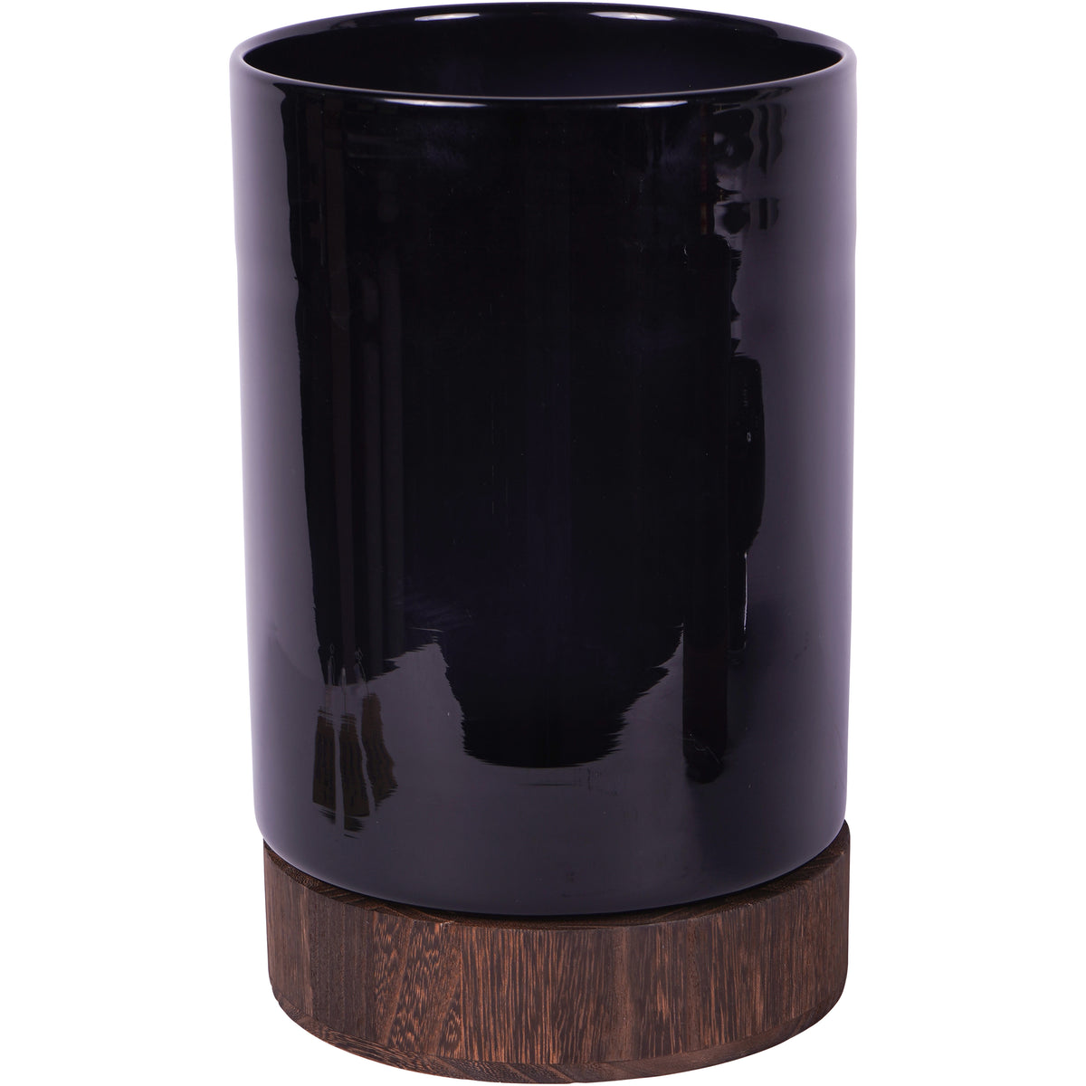 Large cylindrical black glass hurricane vase on a brown wooden base, shown against white.