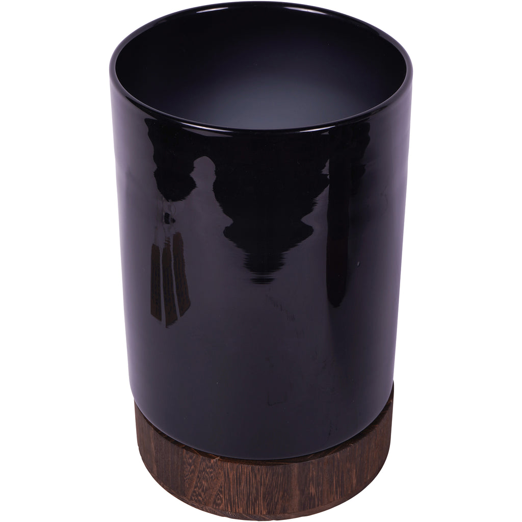 Elevated view of the black glass hurricane vase showing its wide opening and wooden base.