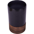 Elevated view of the black glass vessel showing its open top and round wooden base.