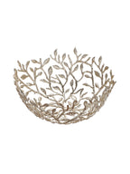 Angled view into a champagne gold openwork bowl formed from branching stems and leaves on a white background.