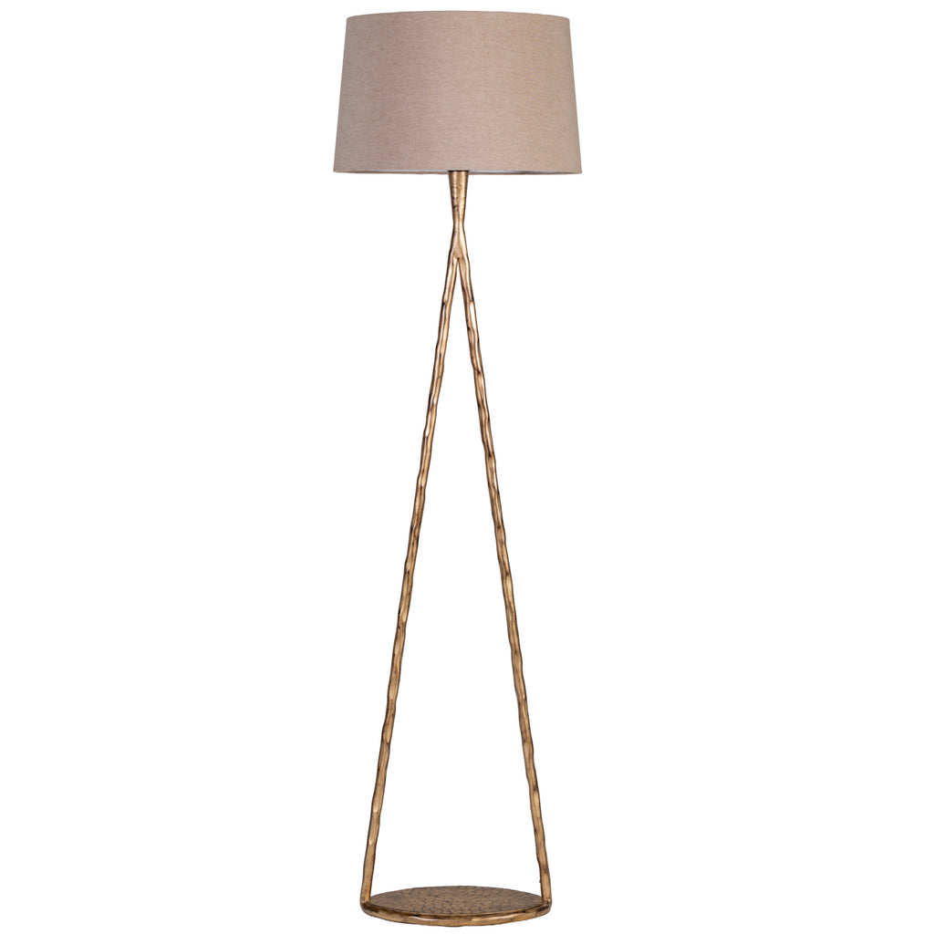 Front view of a gold floor lamp with an open triangular frame, round patterned base and natural-toned fabric shade.