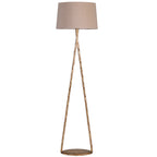 Front view of a gold floor lamp with an open triangular frame, round patterned base and natural-toned fabric shade.