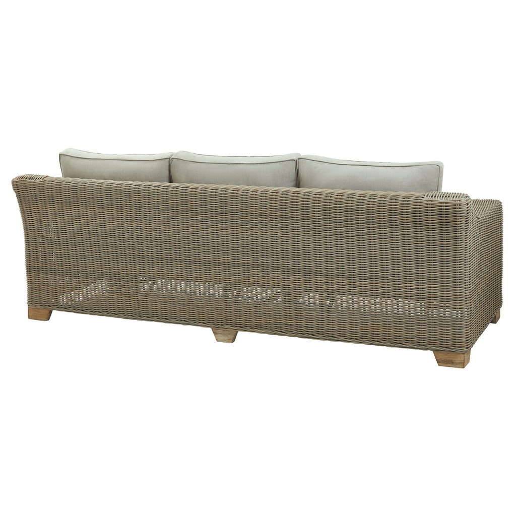 Rear angled view of the sofa showing the grey weave pattern across its rounded back, pale cushions above and short feet below.