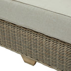 Detail of the pale seat cushion above the sofa's woven-looking front panel and a short foot with a light brown wood-grain appearance.