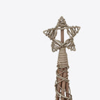 Close-up of the open-centred star topper, wrapped strands and light wire above the narrow tree tip.