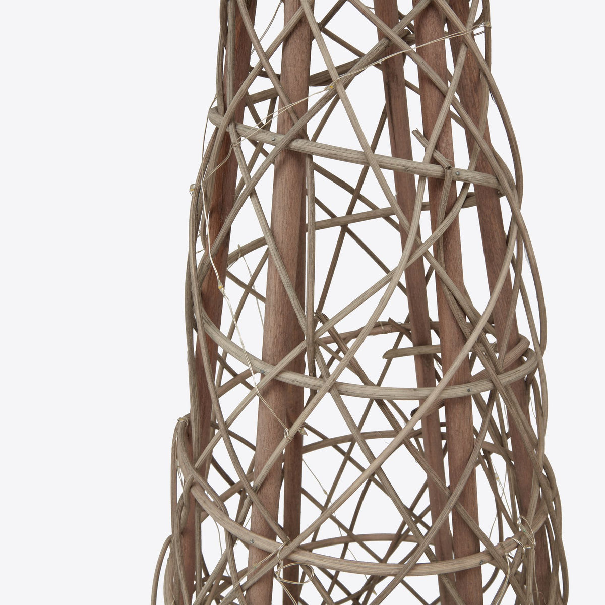 Detail of irregular crossing strands, broader upright lines and fine light wire on the brown tree decoration.