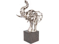 Angled view of a silver-coloured openwork elephant-head sculpture with a raised trunk, curved tusks and broad ears on a black plinth.