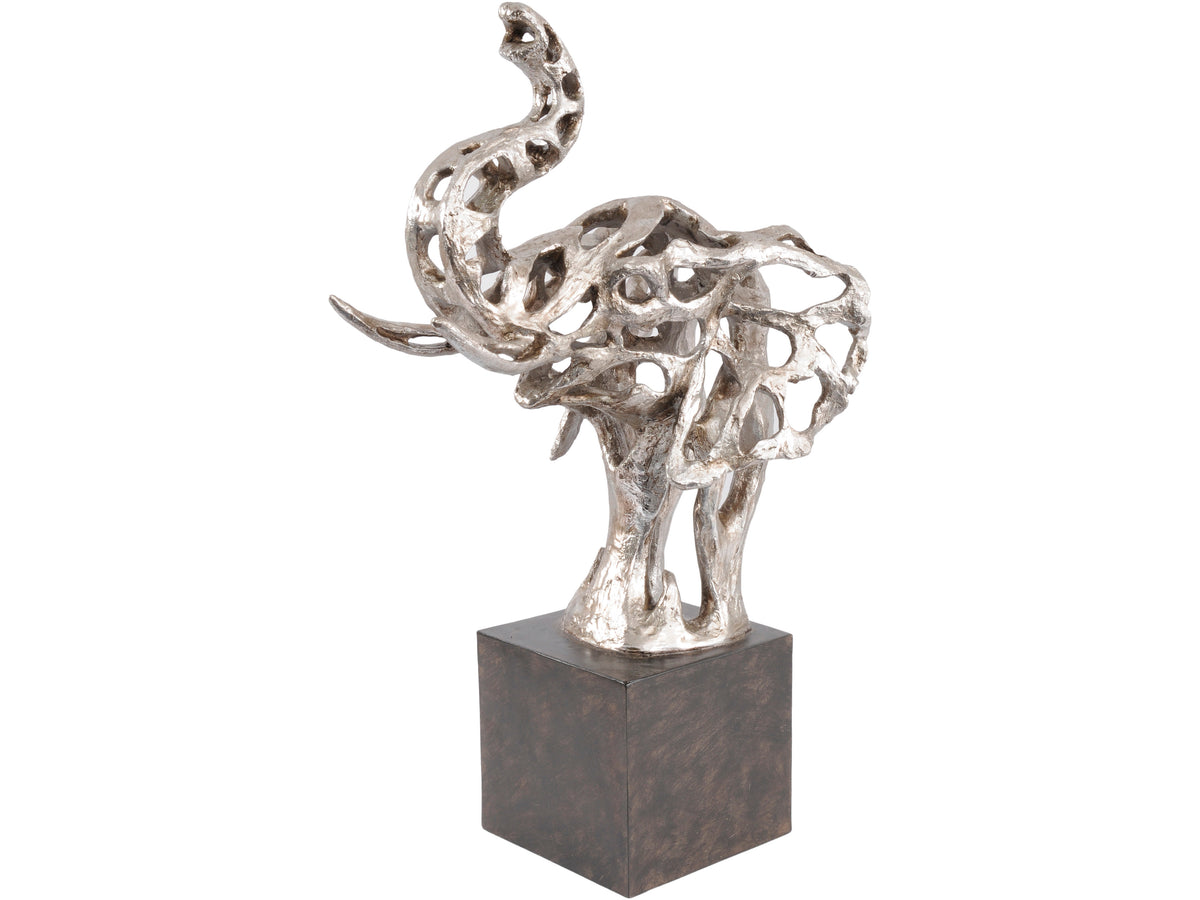 Angled view of a silver-coloured openwork elephant-head sculpture with a raised trunk, curved tusks and broad ears on a black plinth.