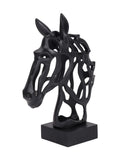 Three-quarter view of a black openwork horse-head sculpture with upright ears and a long muzzle, mounted on a rectangular black base against white.
