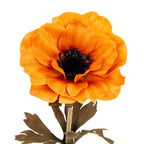 Close-up of the orange artificial flower head, showing overlapping creased petals around a dark round centre, with part of the stem and leaves below.