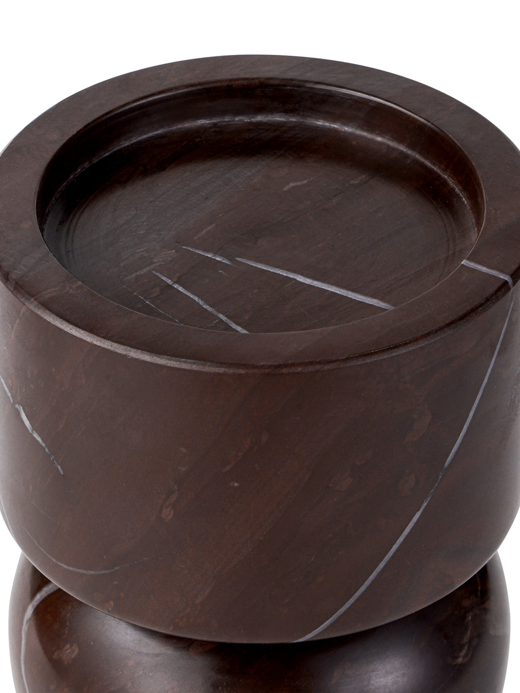 Close-up of the recessed top of the burgundy marble candle holder, with pale veins crossing the platform and rim.