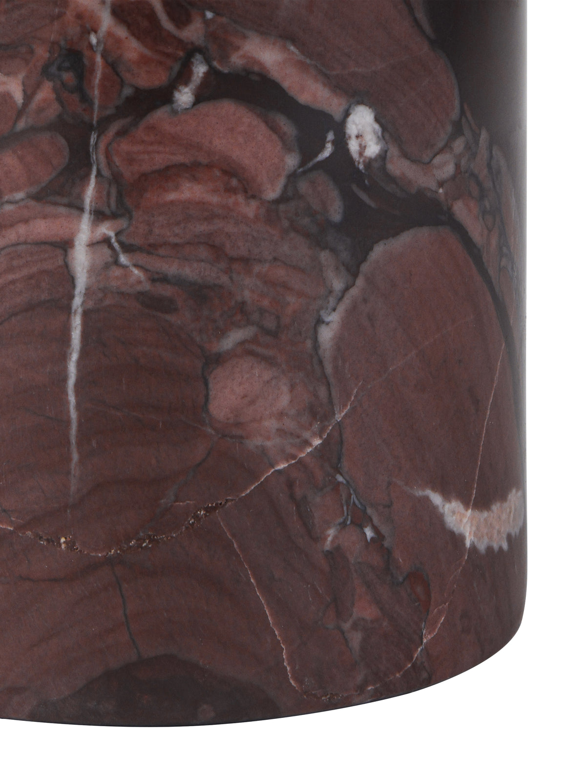 Close-up of the cylindrical marble base, showing red patches, dark lines and pale veins above its curved lower edge.