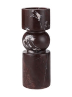 Front view of the dark red marble candle holder, with a rounded centre between cylindrical top and base and pale veining.