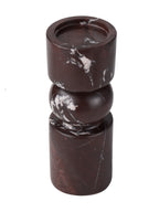 Elevated angled view of the marble candle holder showing its recessed circular top, rounded centre and cylindrical base.