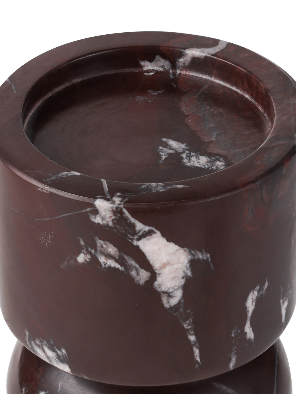 Close-up of the candle holder's recessed top and thick rim, with pale markings across the dark burgundy marble.