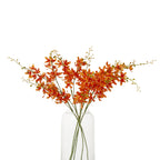 Several orange artificial flower sprays arranged in a clear glass vase, with spreading green branches and buds against a white background.