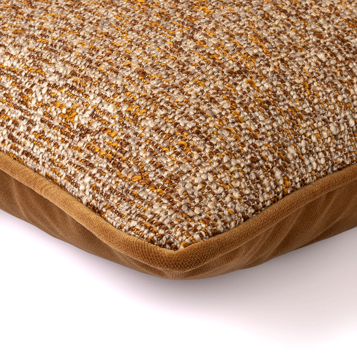 Close-up of the Orien Cushion showing its rust, cream and neutral textured weave with rust velvet border