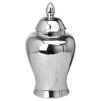 Reflective silver-coloured ginger jar with its domed lid in place, showing an oval finial, rounded shoulders and flared foot against white.