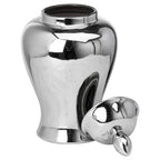 Silver-coloured ginger jar with its open neck visible and the domed lid resting on its side at the front right, oval finial pointing forwards.