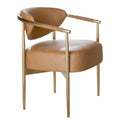 Three-quarter view of a cognac dining chair with a curved shield-shaped back, rounded upholstered seat, contour stitching and rope-wrapped arms on a gold-toned frame.
