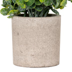 Detail of the cylindrical pot's mottled grey-beige stone-effect surface, with stems and green leaves above the rim.