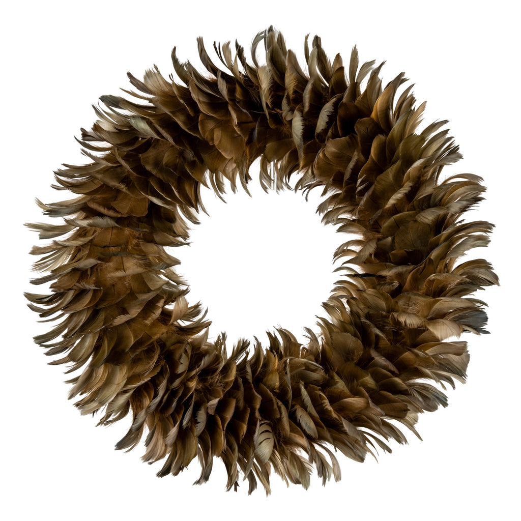 Full view of a circular decorative wreath with an open centre and overlapping brown, tan and olive feather-like forms on a white background.