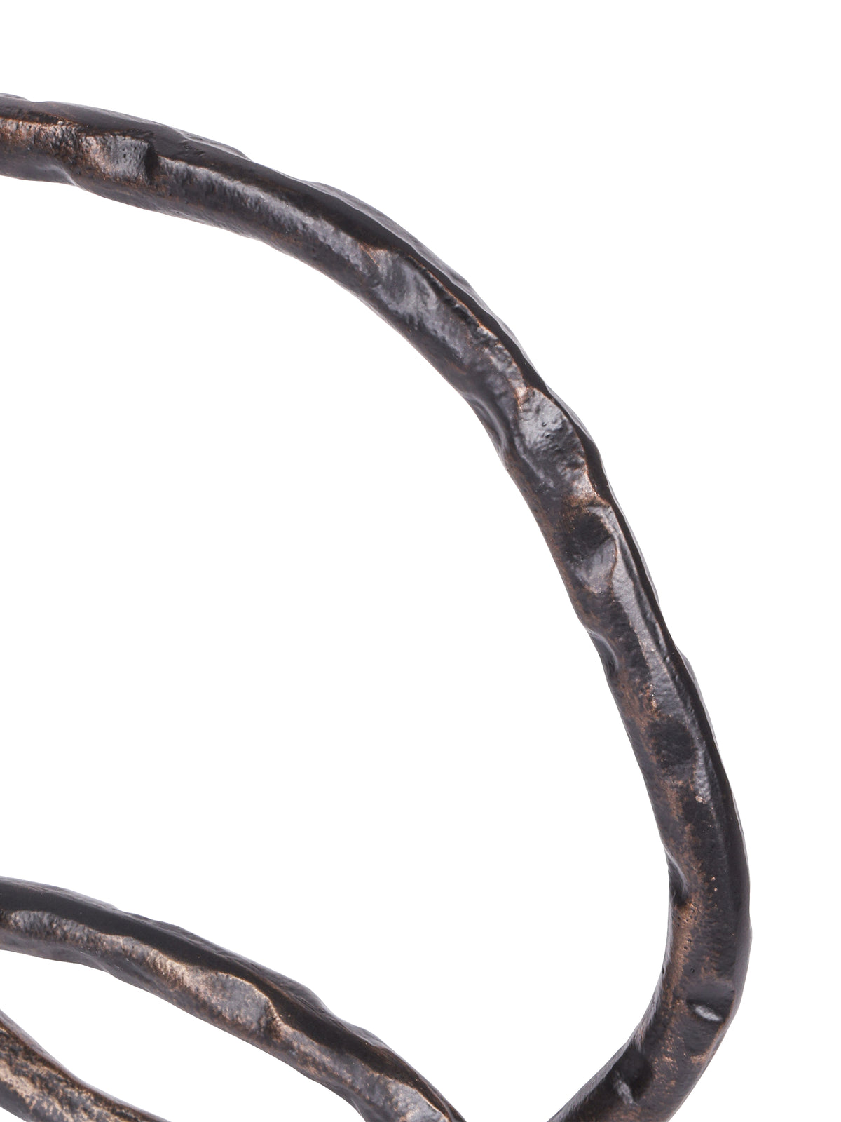 Close-up of an uneven ring edge with a dark textured finish and warm metallic highlights.
