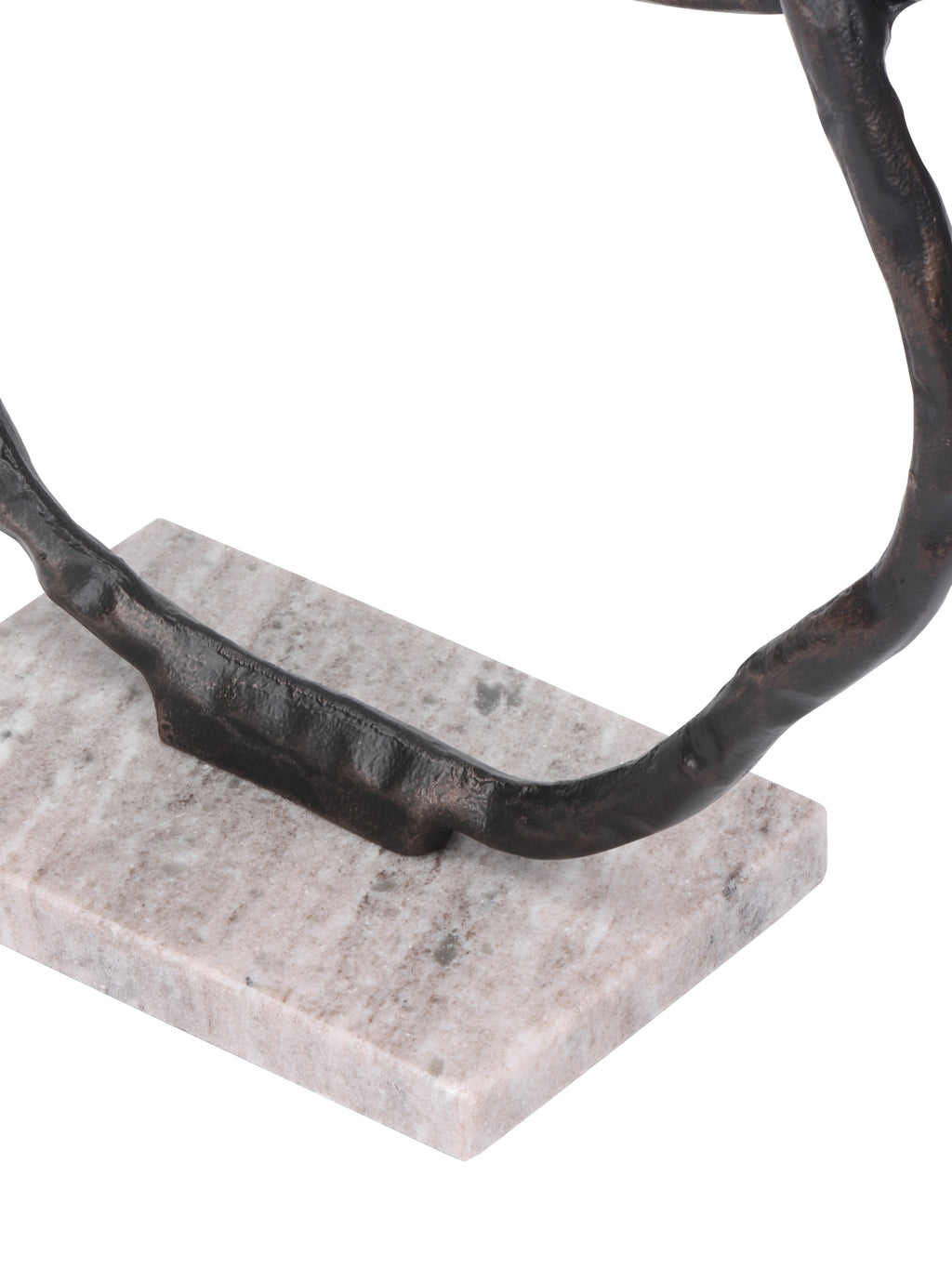 Detail of the lowest dark ring meeting the pale, mottled rectangular marble base.