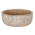 Broad taupe planter viewed from slightly above, showing a warm brown interior, uneven rim and white leafy branches curving across its mottled exterior.