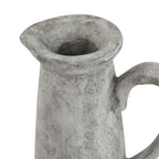 Close view of the jug opening and flared spouted rim, showing darker mottling and the upper curve of the handle.