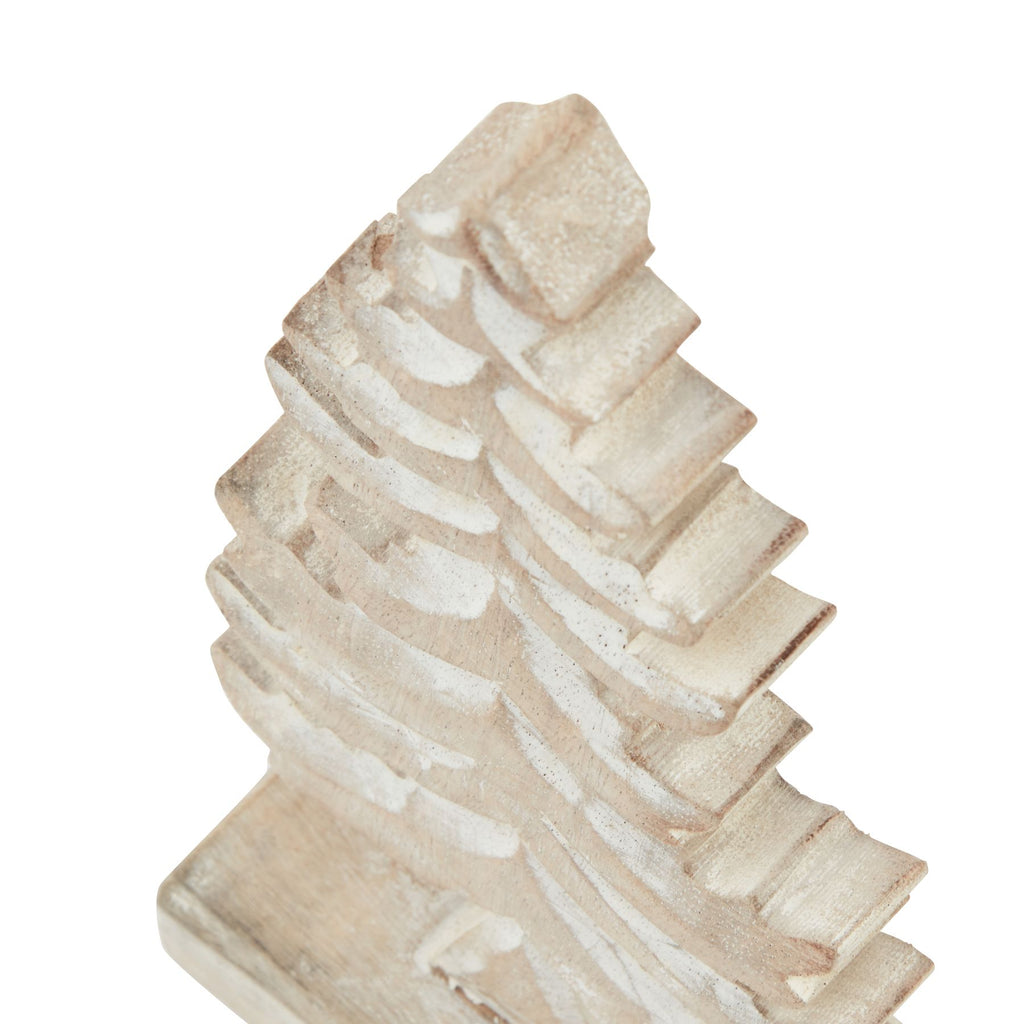 Angled close-up of the tree's upper tiers, showing stepped sides and lighter curved recesses in the pale surface.