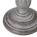 Detail of the lamp's broad circular foot, with concentric ridges and pale rubbed marks around the lower column.