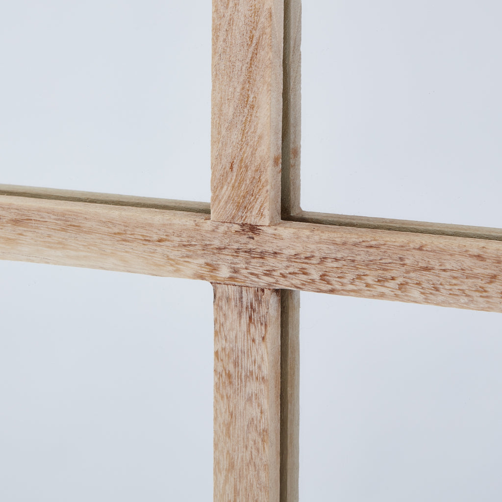 Close-up of the mirror's central crossbars, showing tan grain markings across the pale finish.