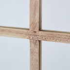 Close-up of the mirror's central crossbars, showing tan grain markings across the pale finish.