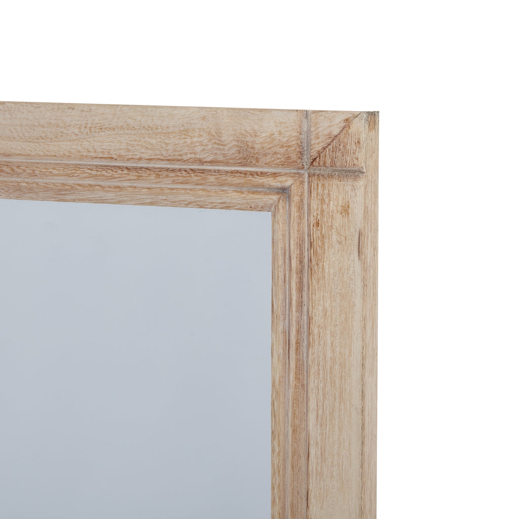 Detail of the mirror's upper right frame corner, with pale grained surfaces and lines running along the inner edge.