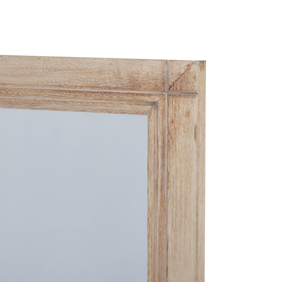Detail of the mirror's upper right frame corner, with pale grained surfaces and lines running along the inner edge.