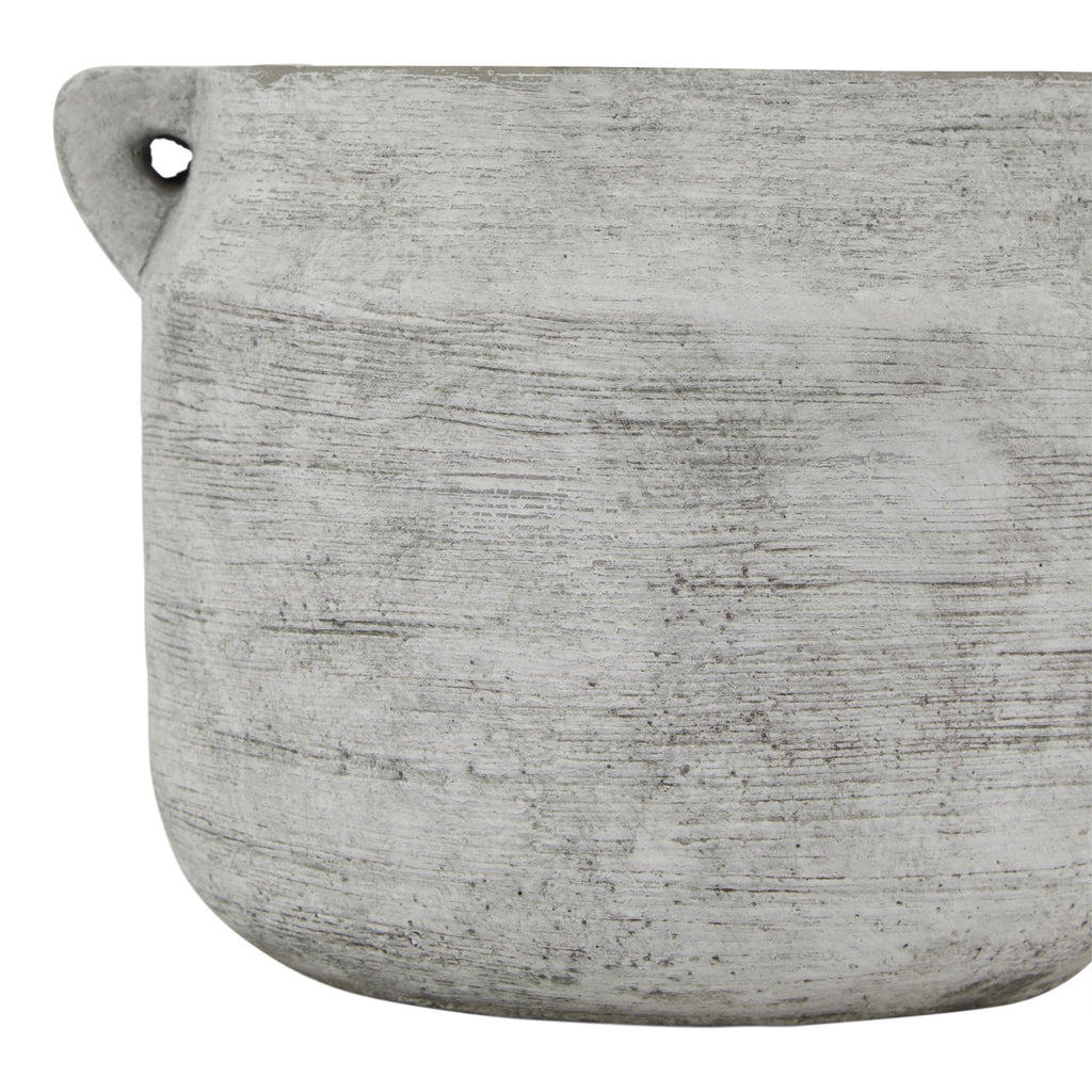 Close-up of the vase's grey-white striated surface, with a loop handle at the upper left and the curved base below.