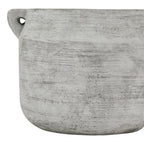 Close-up of the vase's grey-white striated surface, with a loop handle at the upper left and the curved base below.