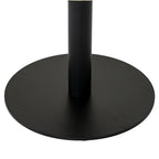 Close-up of the coffee table's dark cylindrical pedestal and flat round base, with a narrow edge of the pale top visible above.