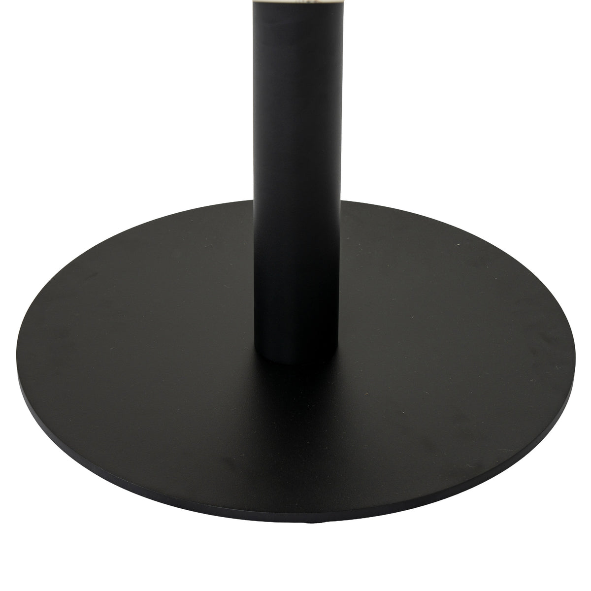 Close-up of the coffee table's dark cylindrical pedestal and flat round base, with a narrow edge of the pale top visible above.