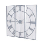 Angled view of the Panel Roman Wall Clock with three whitewashed rectangular panels, grey Roman numerals and ornate hands.