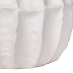 Detail of the vase's lower panelled sides, showing the matte-white texture and small surface irregularities.