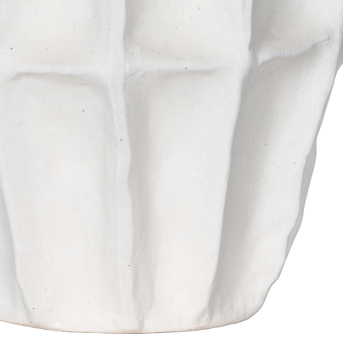 Detail of the vase's lower body, showing softly raised panels and fine speckling in the matte-white surface.