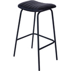 Angled view of a single charcoal bar stool showing the padded seat, four slender legs and wraparound footrest.
