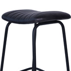 Low angled detail of the curved, channel-stitched charcoal seat above the rounded black leg frame.