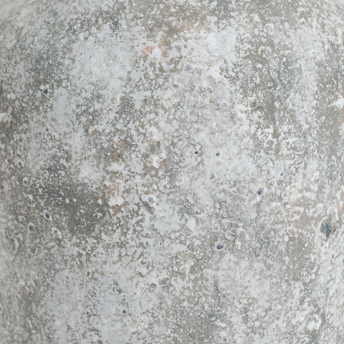 Close-up of the Patchneck Vase surface with irregular pale patches, grey areas and small darker marks.