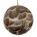 Close-up of the bauble's overlapping feather-like shapes, showing fine lines and cream bands across the grey-brown surface.